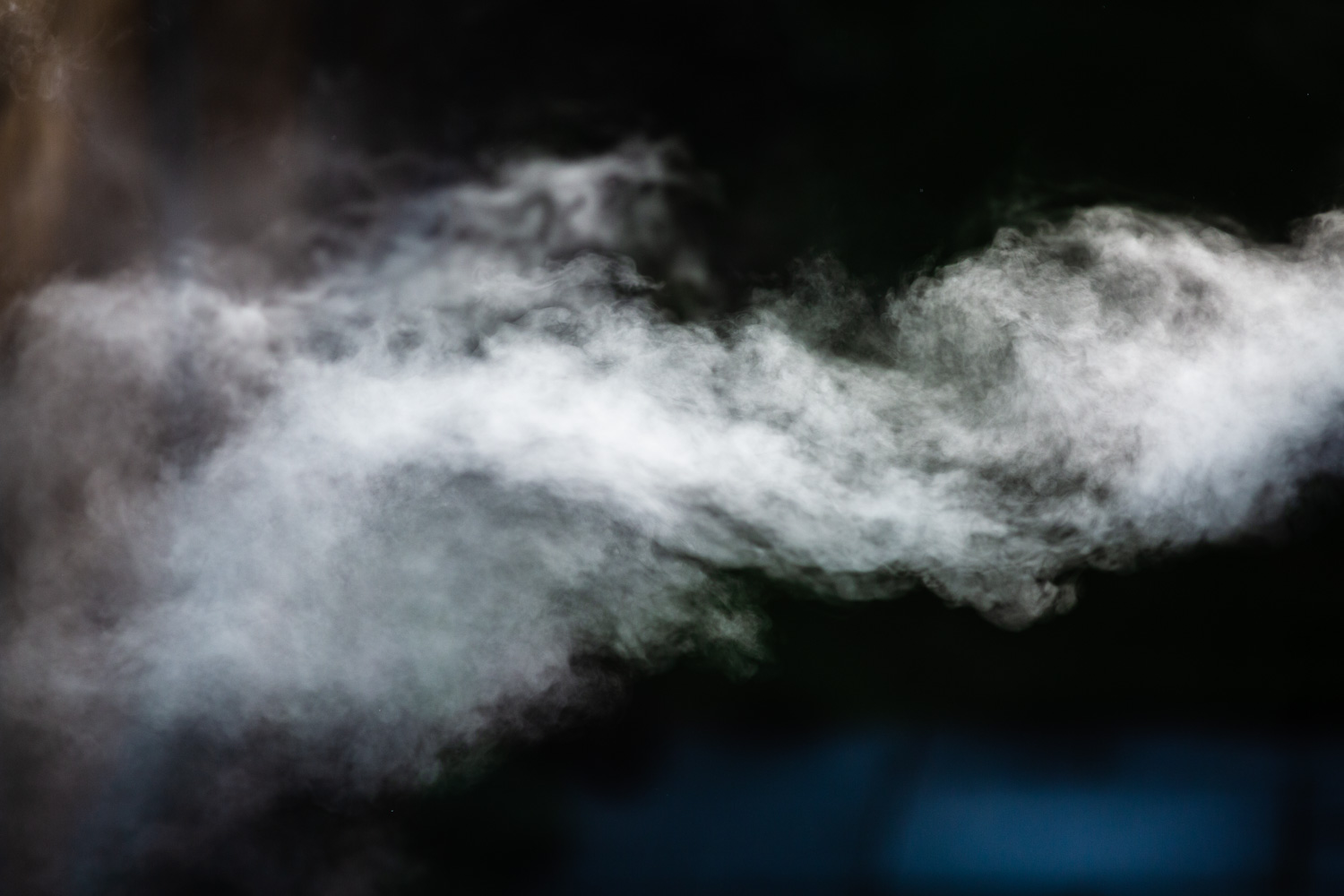 10 happy minutes trying to catch the steam. Photograph of white steam against a dark background.